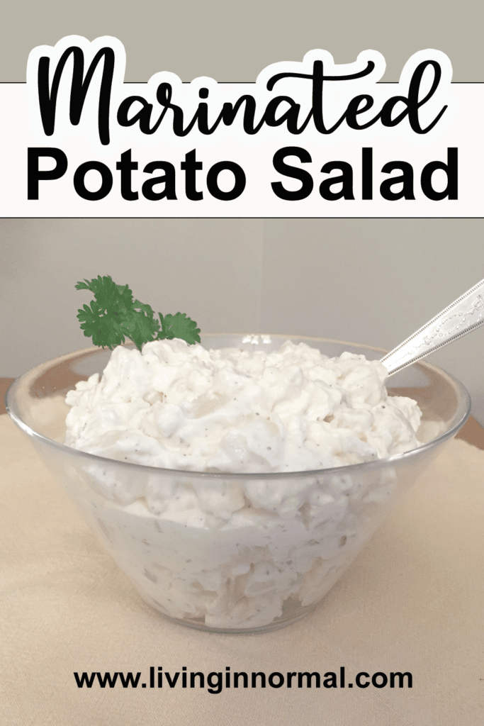 pinterest image of marinated potato salad in a bowl with a spoon and parsley for garnish