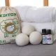 wool dryer balls and essential oil in front of folded towels