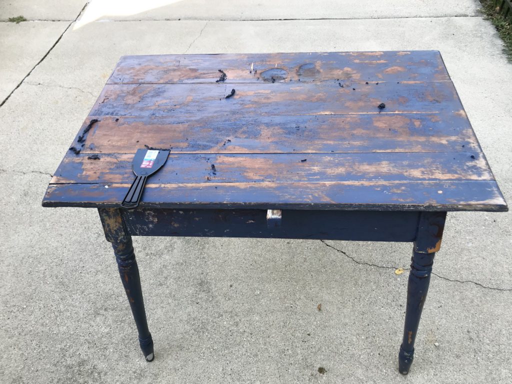 blue mini farmhouse table with one layer of paint stripped