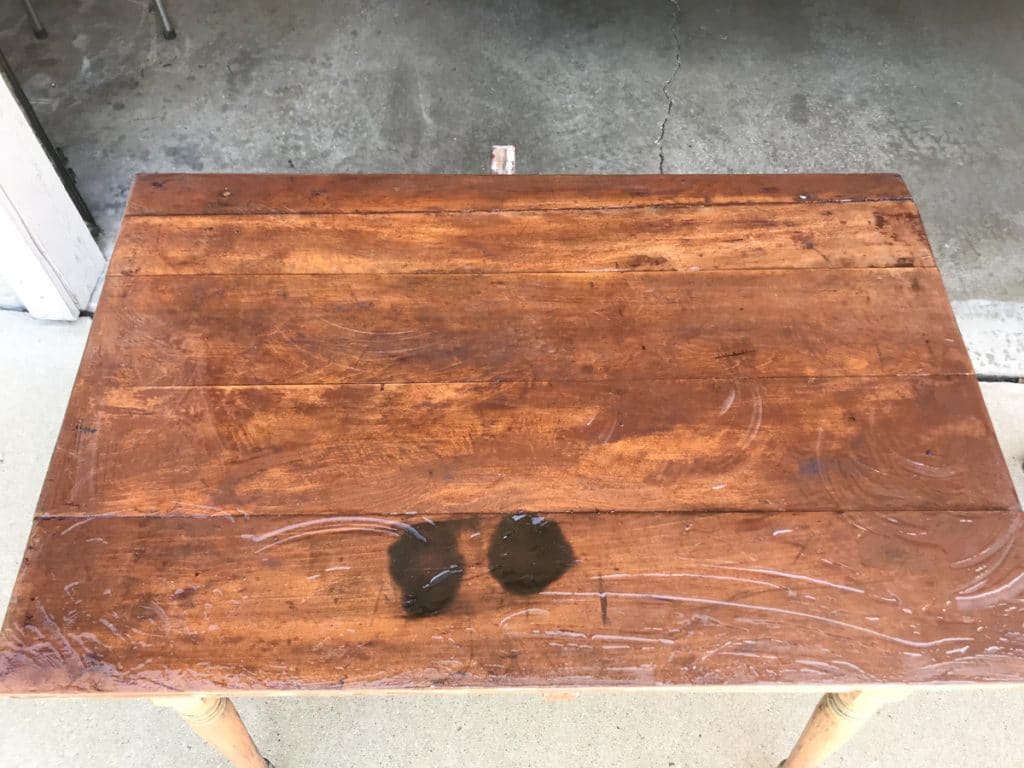 coating of paint stripper on table