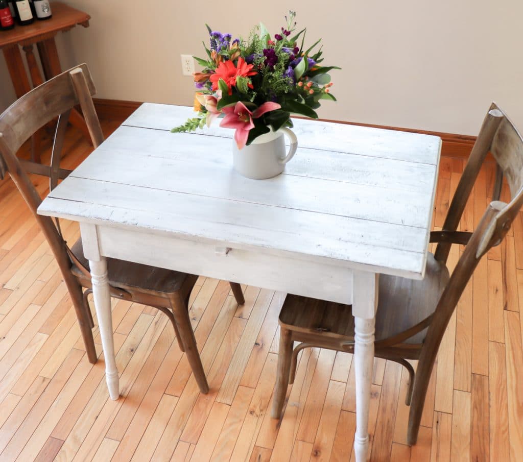 white painted wood furniture with flowers on the table
