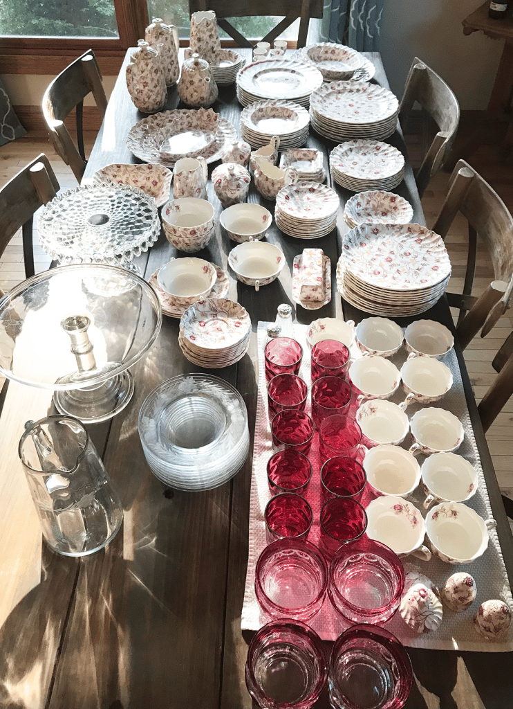 table with all of the china and other dishes