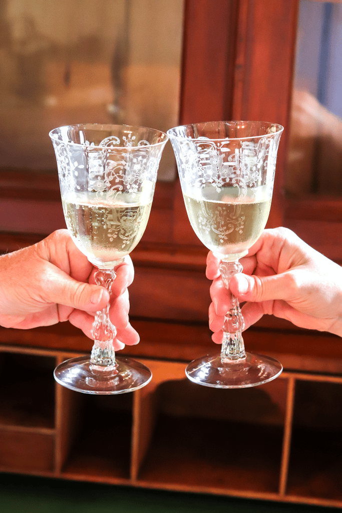 Toasting with champagne filled crystal glassware