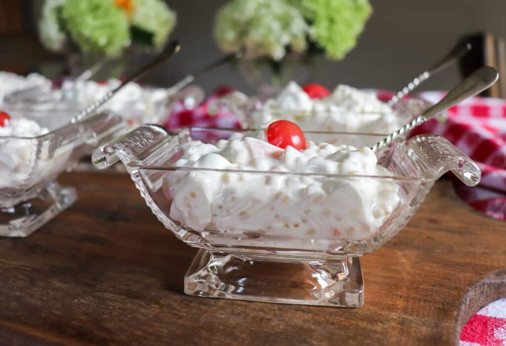 little glass dishes with little bowls of Macedonia di Frutta with cherries on top
