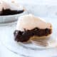 Slice of Old Fashioned Chocolate Meringue Pie sitting on a clear plate.