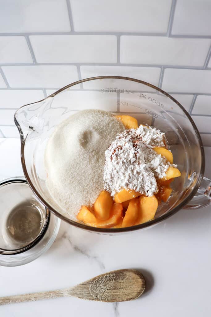 Ingredients for peach mixture in a glass bowl.
