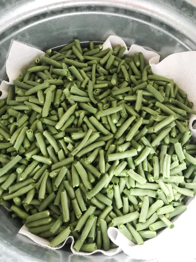 Green beans broken into a bowl.