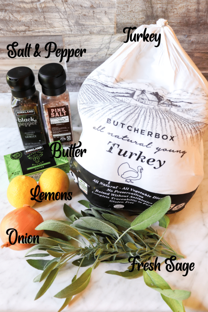 Ingredients needed to make a slow cooked turkey. Ingredients include turkey, sage, lemon, onion, butter, salt, and pepper.