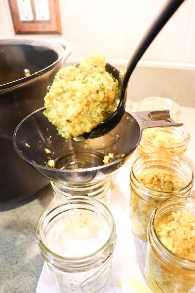 Filling the jars with the hot vegetable mixutre.