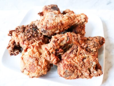 Pile of chicken on a white plate.