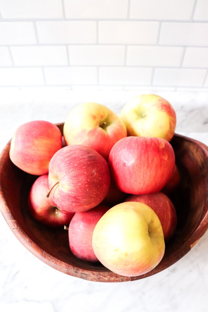 Honeycrisp apples in a wooden bowl.